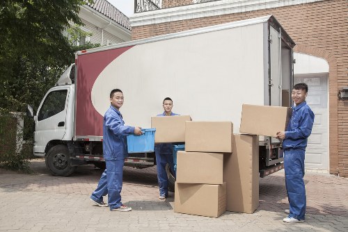 Removal team working in a Shoreditch street with moving van and boxes