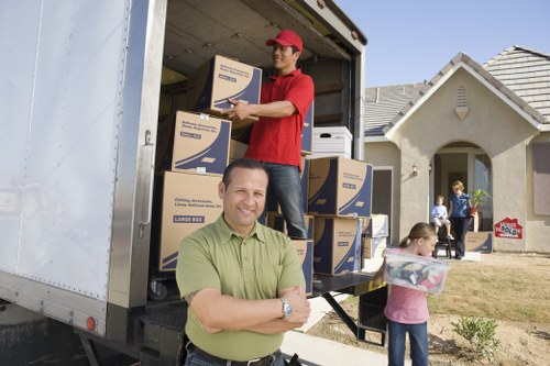 Removal team safely loading boxed household items into a van
