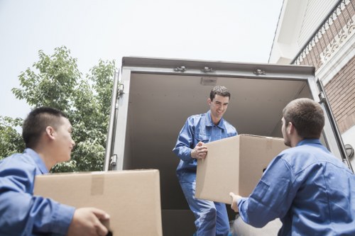 Moving crew carrying a sofa from a Shoreditch apartment building