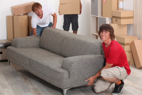 Two workers carrying a heavy item with correct lifting posture