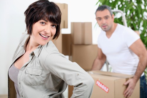 Professional movers loading furniture for a same day removal